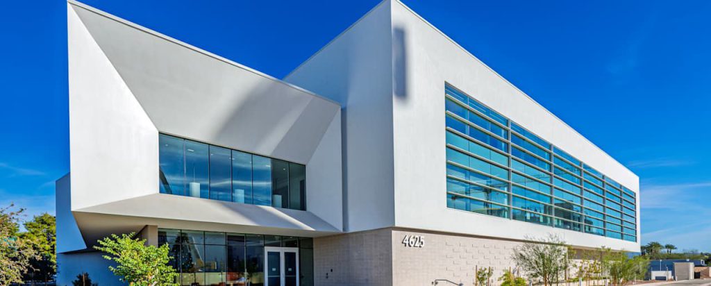 White angular building with long bands of windows