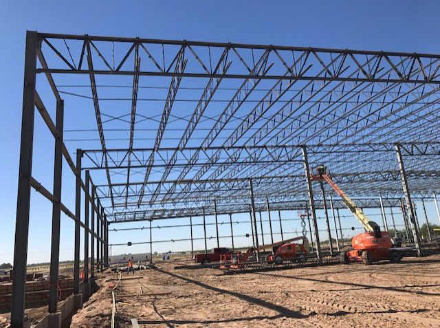 Steel frame of a large building with a lift on site